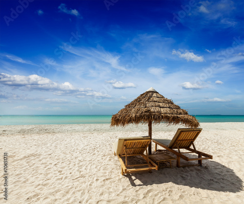 Two beach lounge chairs under tent