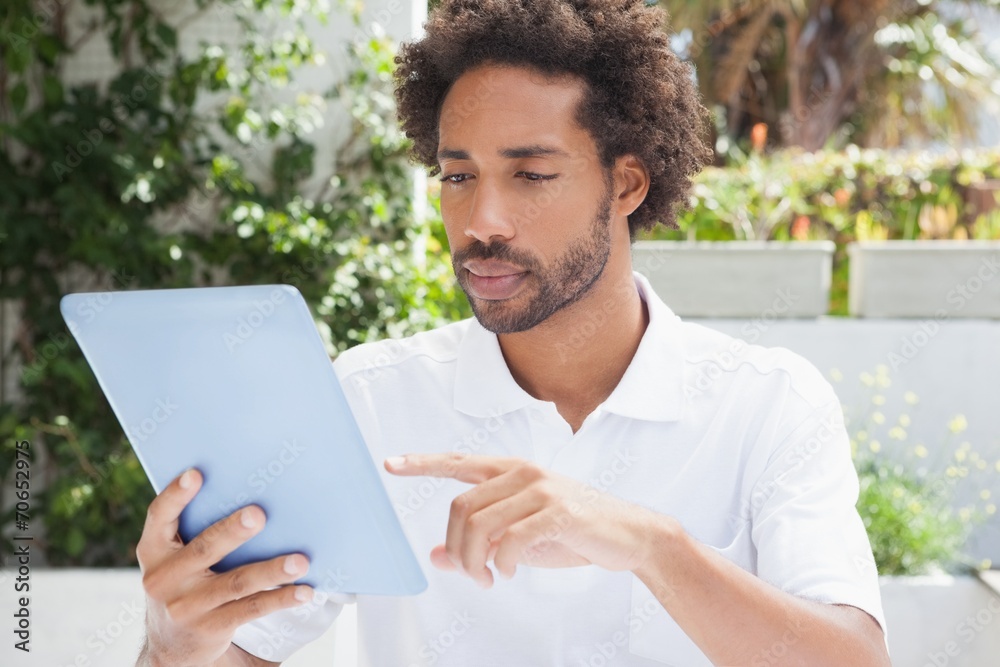 Thoughtful man having a coffee using tablet Thoughtful man having a coffee using tablet