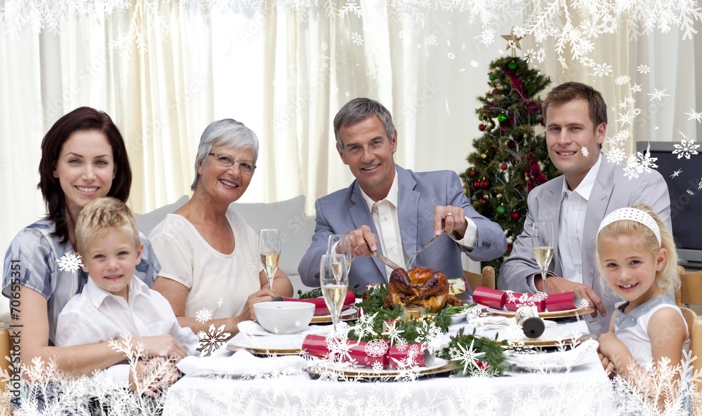 Composite image of family eating turkey in christmas eve dinner