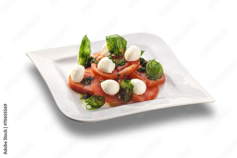 Artistically arranged tomato salad with mozzarella garnished wit Artistically arranged tomato salad with mozzarella garnished wit