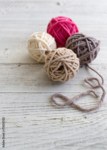 Balls of wool on wooden background