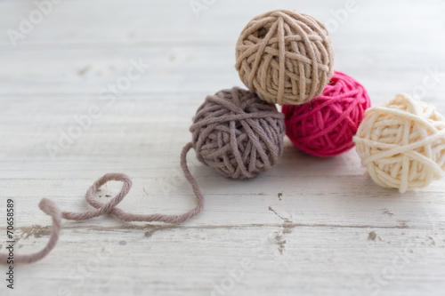 Balls of wool on wooden background