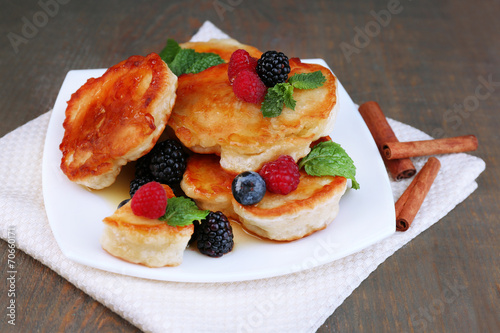 Tasty pancakes with fresh berries, honey and mint leaf