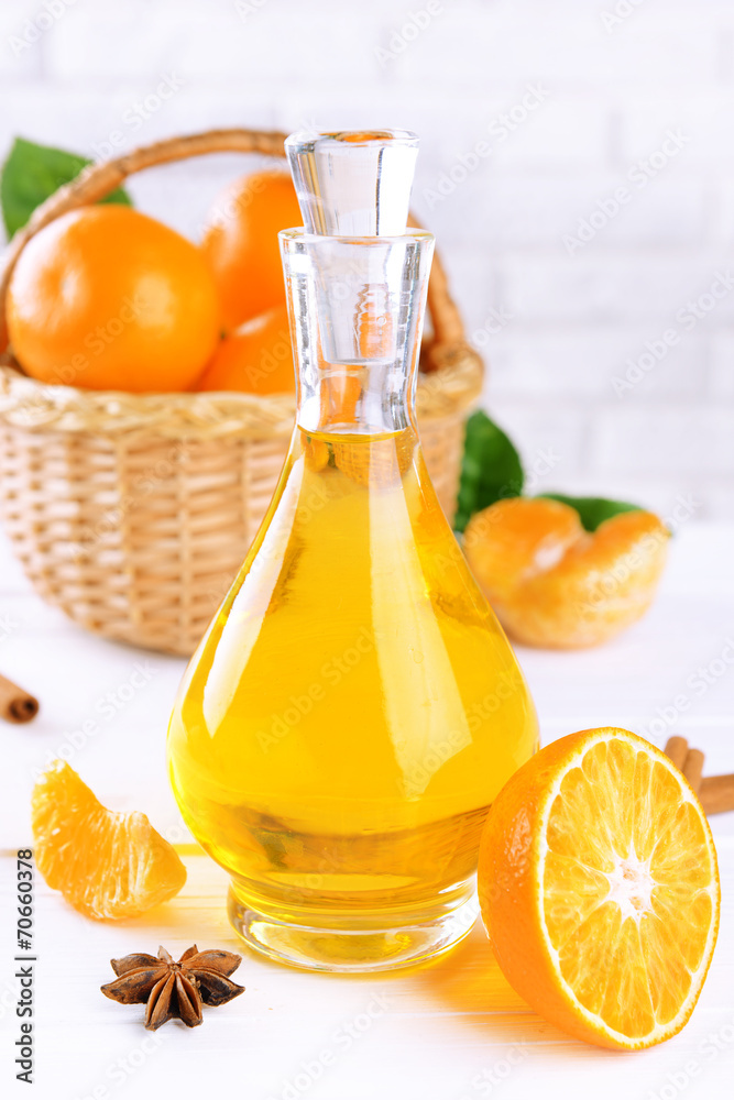 Tangerine oil on table on light background