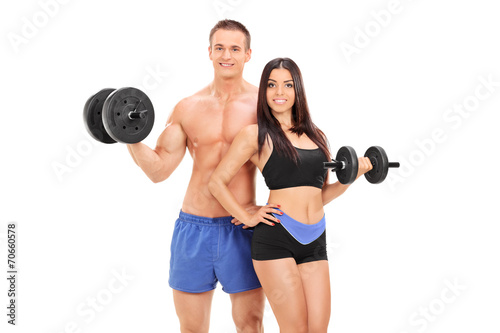 Male and female athletes posing with barbells