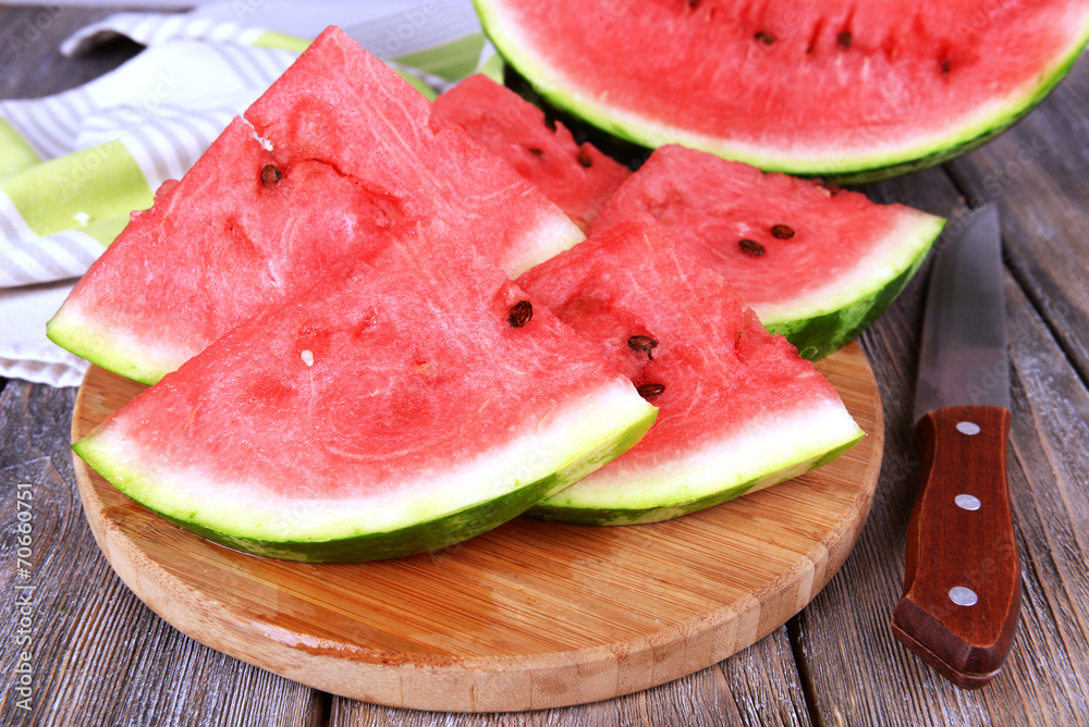 Slice of watermelon on wooden table Slice of watermelon on wooden table