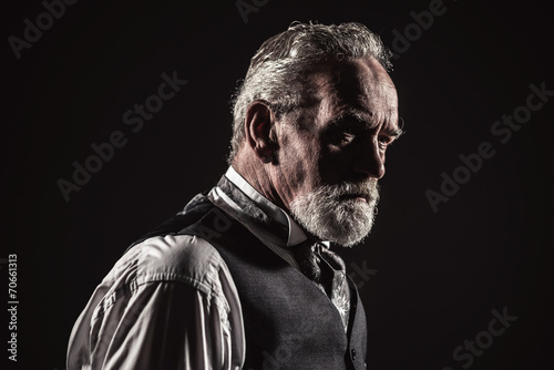 Vintage characteristic senior man with gray hair and beard. Stud