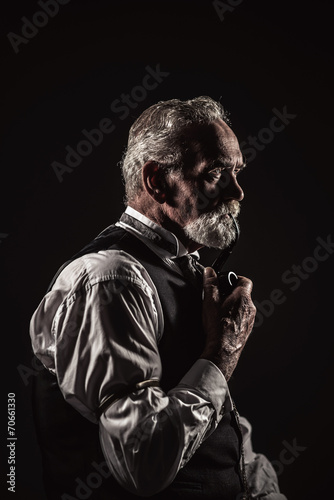 Pipe smoking vintage characteristic senior man with gray hair an