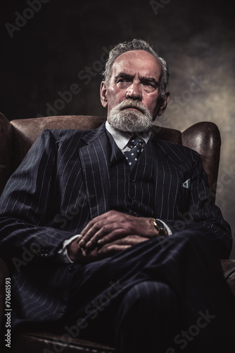 In chair sitting characteristic senior business man. Gray hair a © ysbrandcosijn