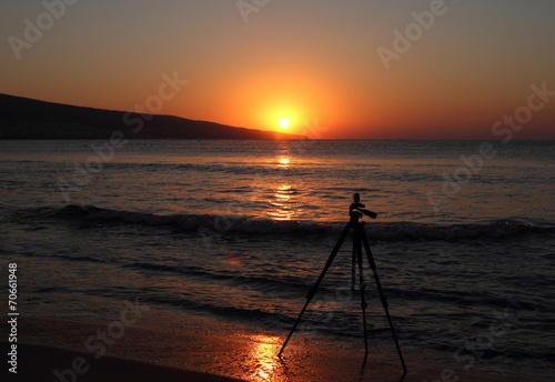 tripod on the background of sunrise over black sea