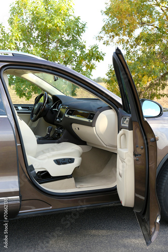 Modern car with open door, outdoors