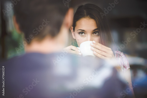 Young couple on first date drinking coffee photo