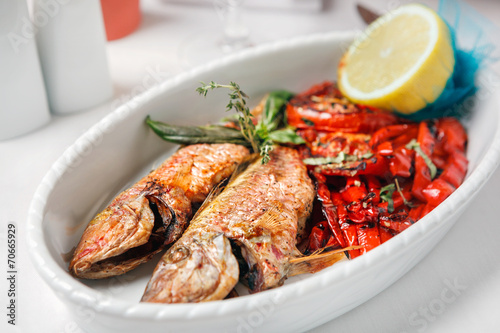 Fried fish with red peppers and lemon.