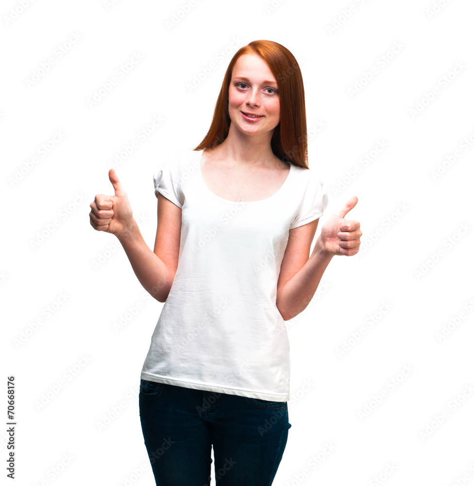 Red-haired girl showing thumbs up. Isolated on white background Red-haired girl showing thumbs up. Isolated on white background