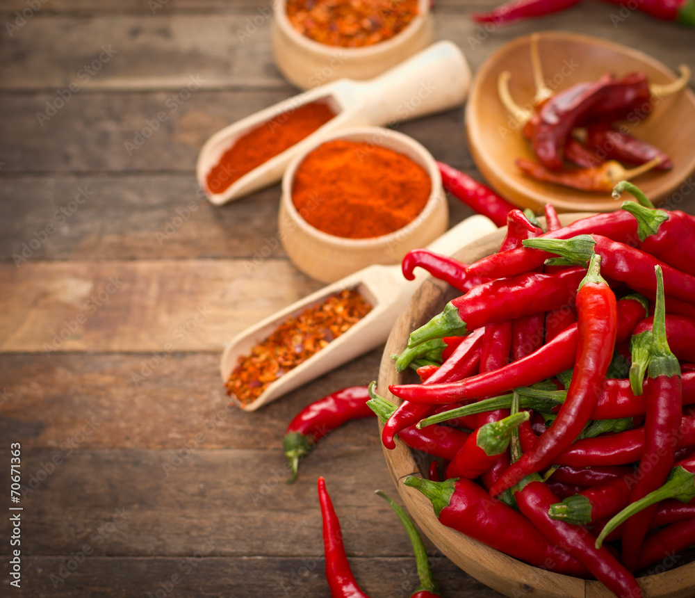 Red chili peppers and spices on the table Red chili peppers and spices on the table