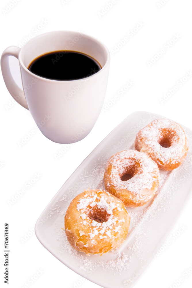 A mug of coffee and homemade doughnut with sugar toppings A mug of coffee and homemade doughnut with sugar toppings