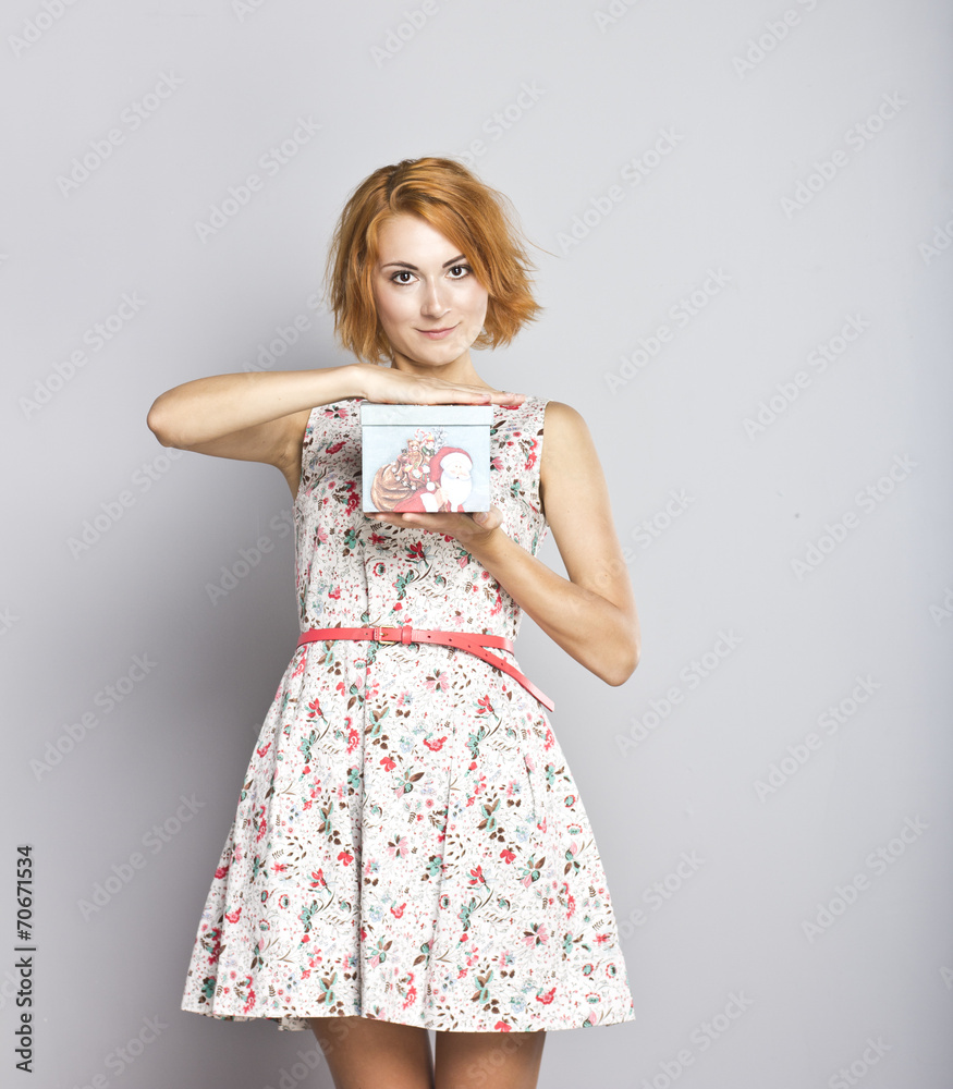 Beautiful red-haired girl with a Christmas present Beautiful red-haired girl with a Christmas present