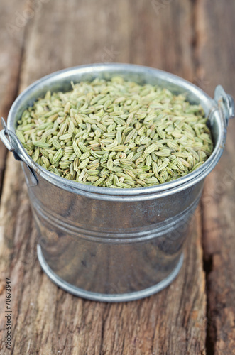 fennel seeds on wooden surface
