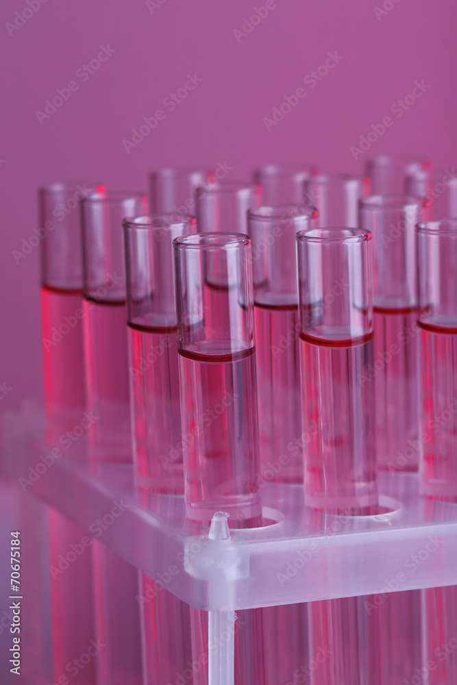 Test-tubes with blue liquid on purple background Test-tubes with blue liquid on purple background