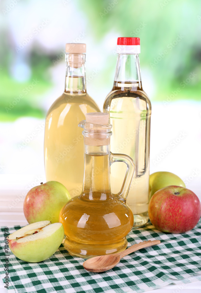 Apple cider vinegar in glass bottles and ripe fresh apples, Apple cider vinegar in glass bottles and ripe fresh apples,
