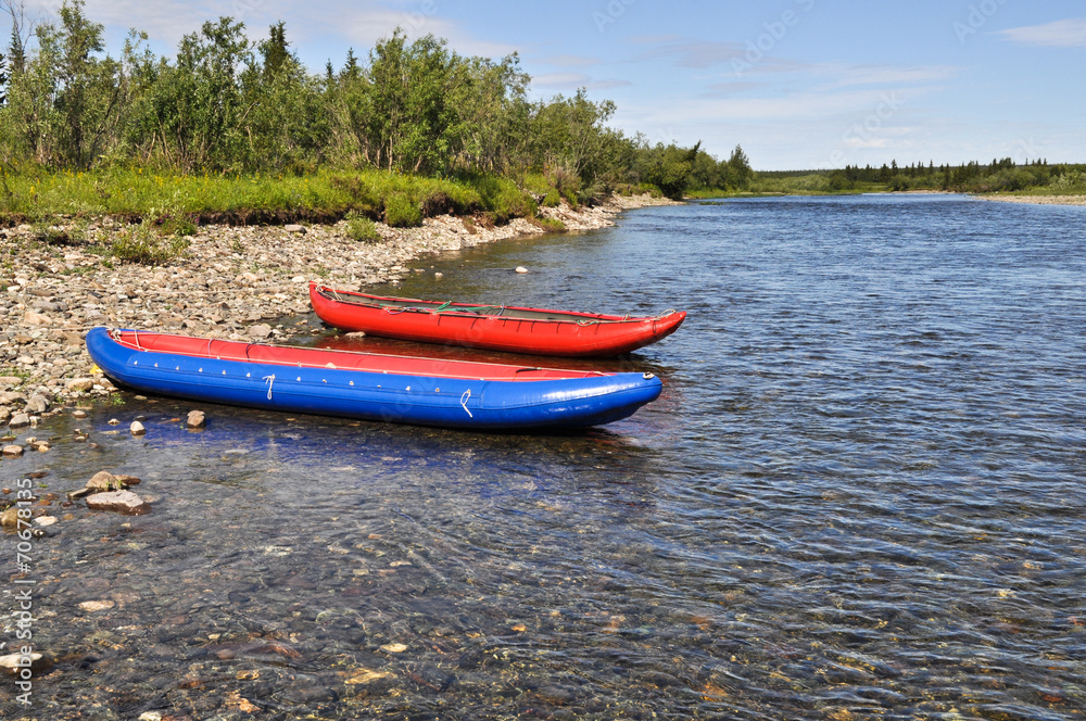 Two inflatable canoes on the shore of North river. Two inflatable canoes on the shore of North river.
