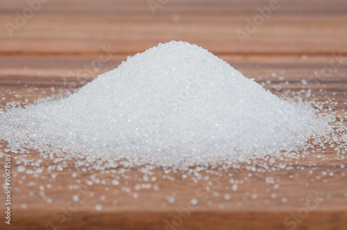 Sugar on wooden table.
