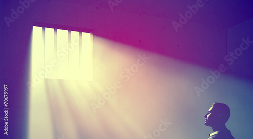 prisoner in dark room with light beams