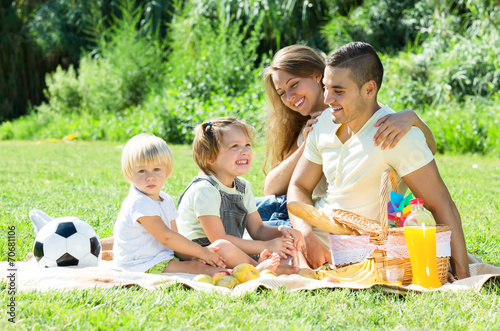 European family with children having picnic