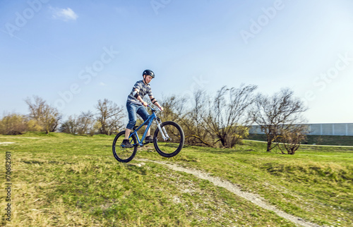 teenage boy racing with his dirt bike