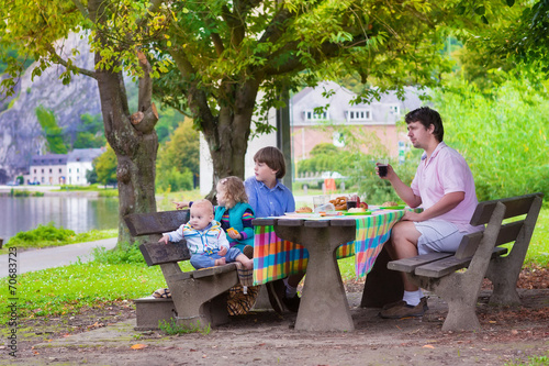 Happy father and kids at picnic