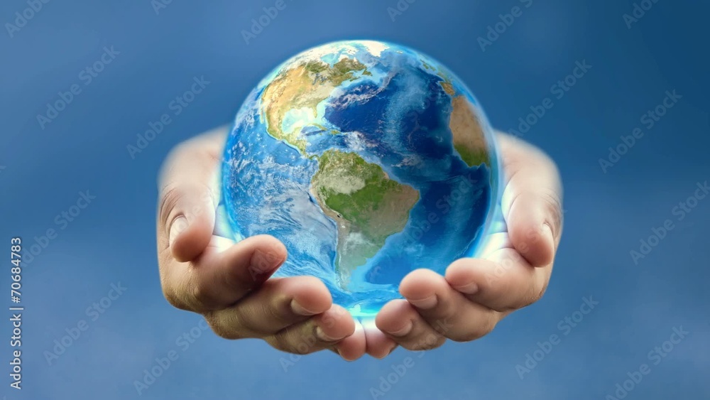 Earth in man's hands – blue background