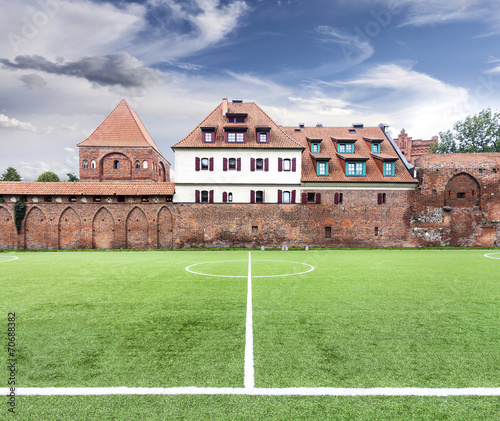 View of Torun old town with a football field, Poland