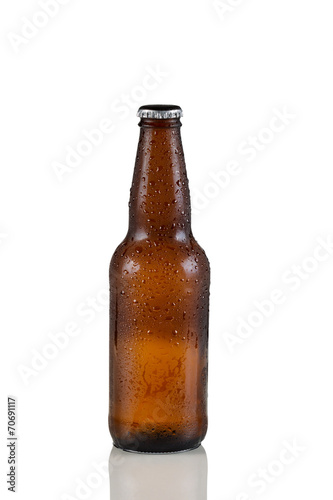 Unopened cold beer bottle on white with reflection