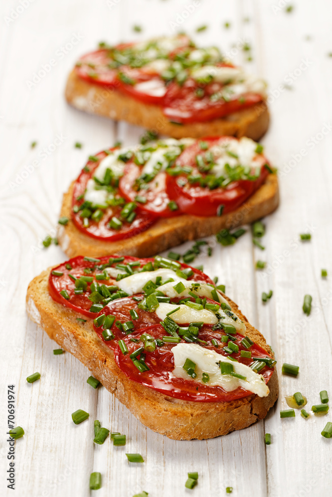 Bruschetta with fresh tomato,  cheese  and chive