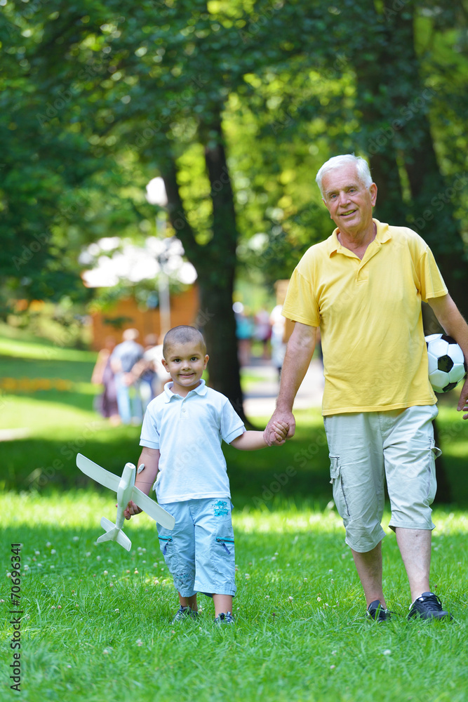 Fototapeta premium happy grandfather and child in park
