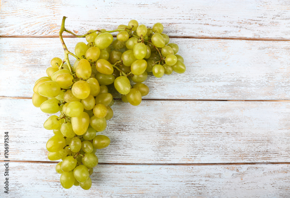 Bunch of ripe grapes on grey wooden background Bunch of ripe grapes on grey wooden background