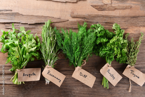 Different fresh herbs on wooden background