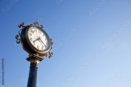 clock post with blue sky