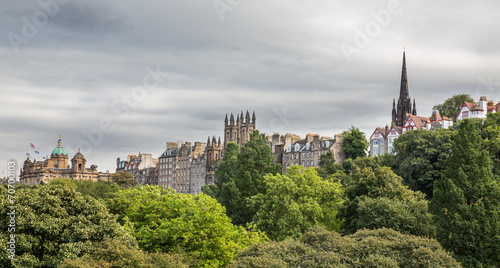 View of old Edinburgh houses and park against cloudy sky