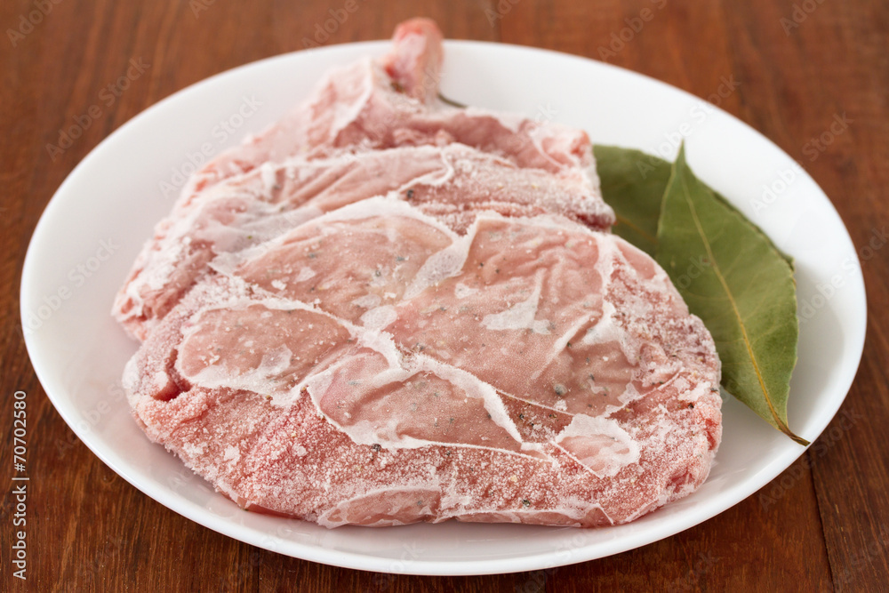 frozen pork on plate frozen pork on plate
