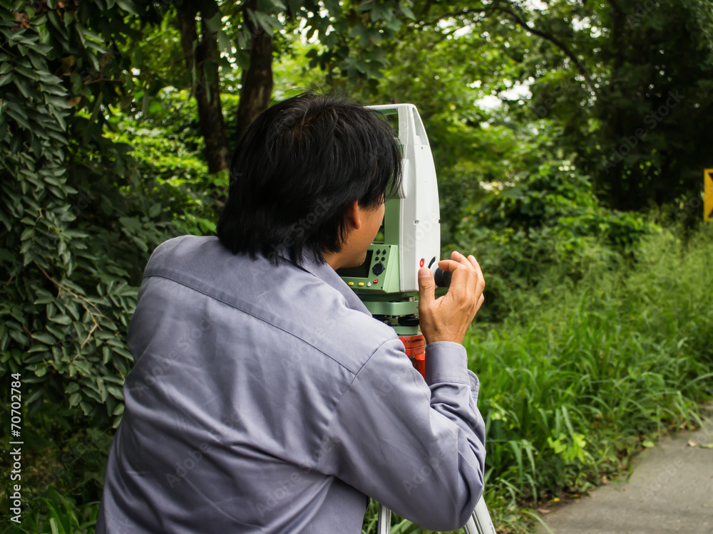 Portrait of builder worker with theodolite