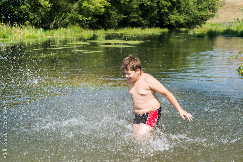 Fototapeta premium Full 10 years boy swim in river