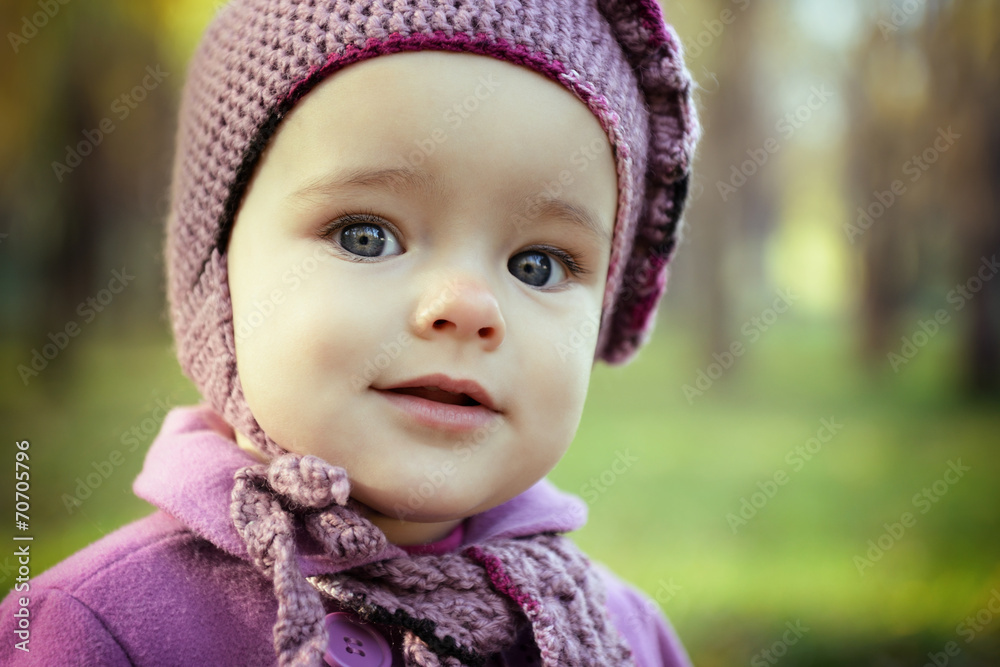 Portrait of cute liitle girl playing in autumn park. Baby face c Portrait of cute liitle girl playing in autumn park. Baby face c