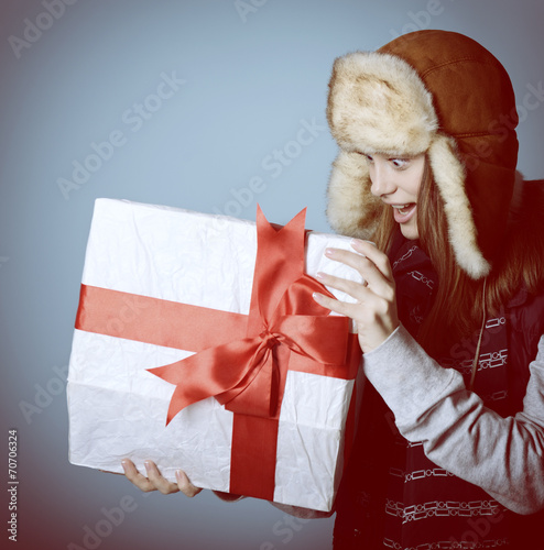Portrait of attractive excited christmas girl in winter hat open