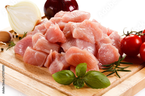 Raw tourkey meat on cutting board on white background photo