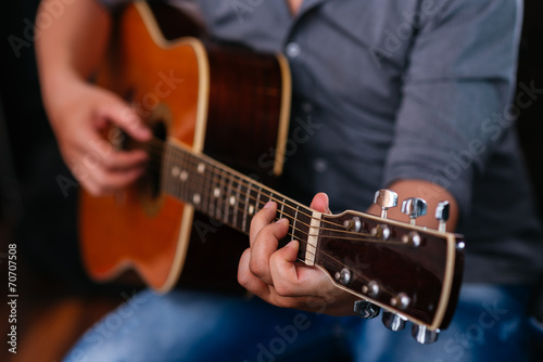 Playing acoustic guitar