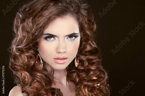 Beauty fashion girl. Wavy long hair. Brunette model with makeup