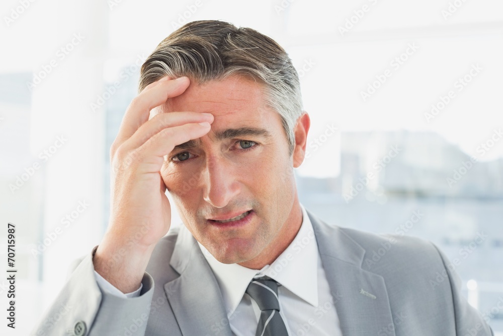 Businessman suffering from a headache Businessman suffering from a headache