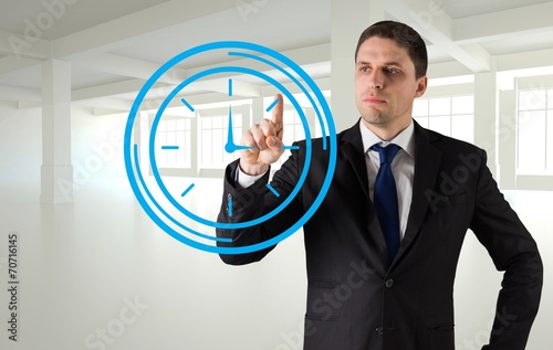 Composite image of businessman standing and pointing