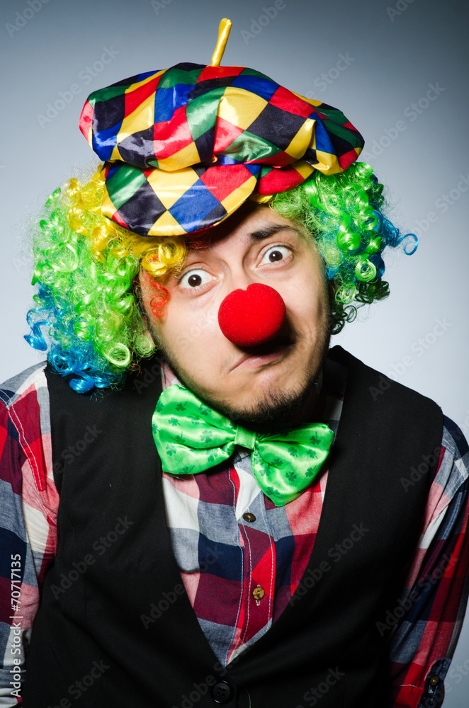 Funny clown against the dark background Funny clown against the dark background
